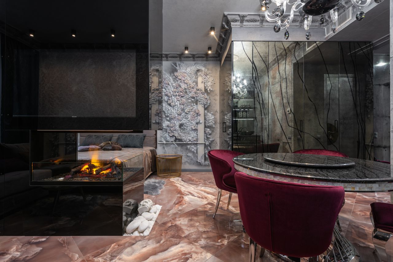 gallery-2 Stylish modern interior featuring a luxurious fireplace and elegant dining setup.