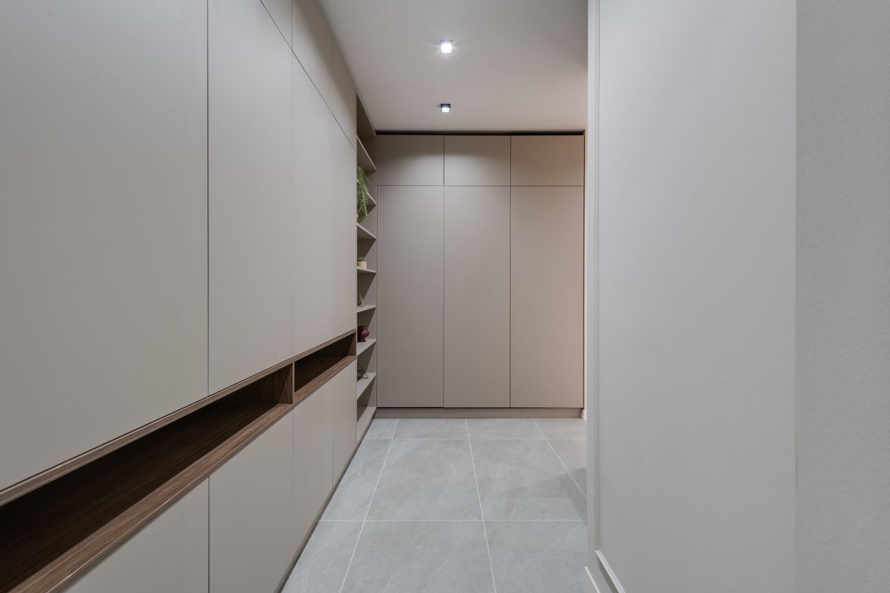 services-03 Explore a contemporary minimalist hallway featuring sleek modern cabinetry and neutral colors.